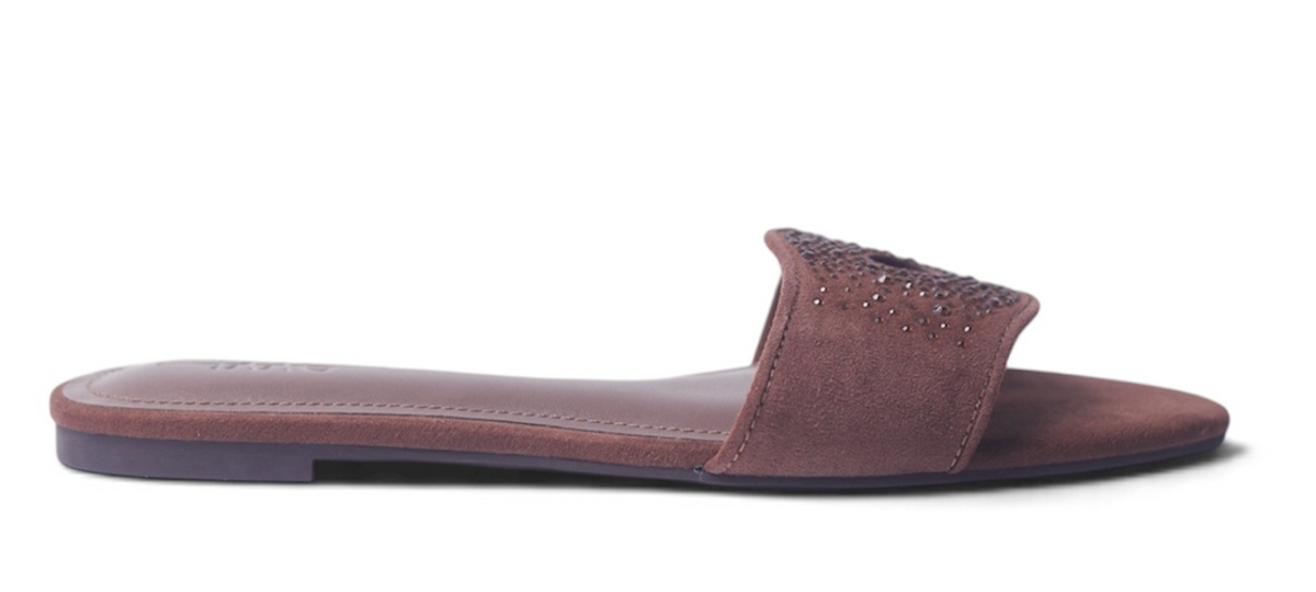 A single women's flat slide sandal in a dusty rose-brown suede-like material, featuring a wide strap embellished with small metallic studs, shown in profile against a white background.